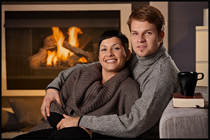 Happy couple in front of fireplace, Kugel Quality Fireplaces, Tampa Bay, Florida